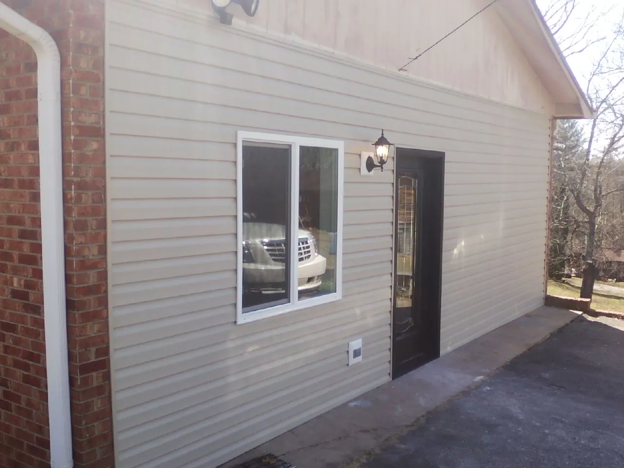 New vinyl siding and entry door on a room addition in Verplanck