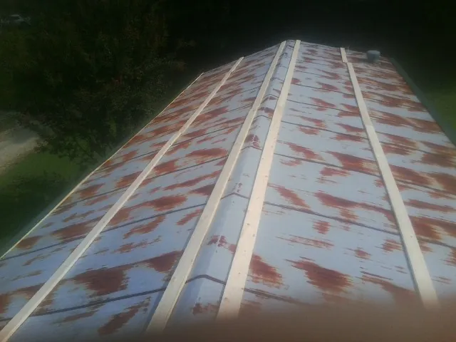 Rusted metal roof panels with new wood purlins before replacement — Storm Damage Roof Repair in Verplanck by Roofing Brothers