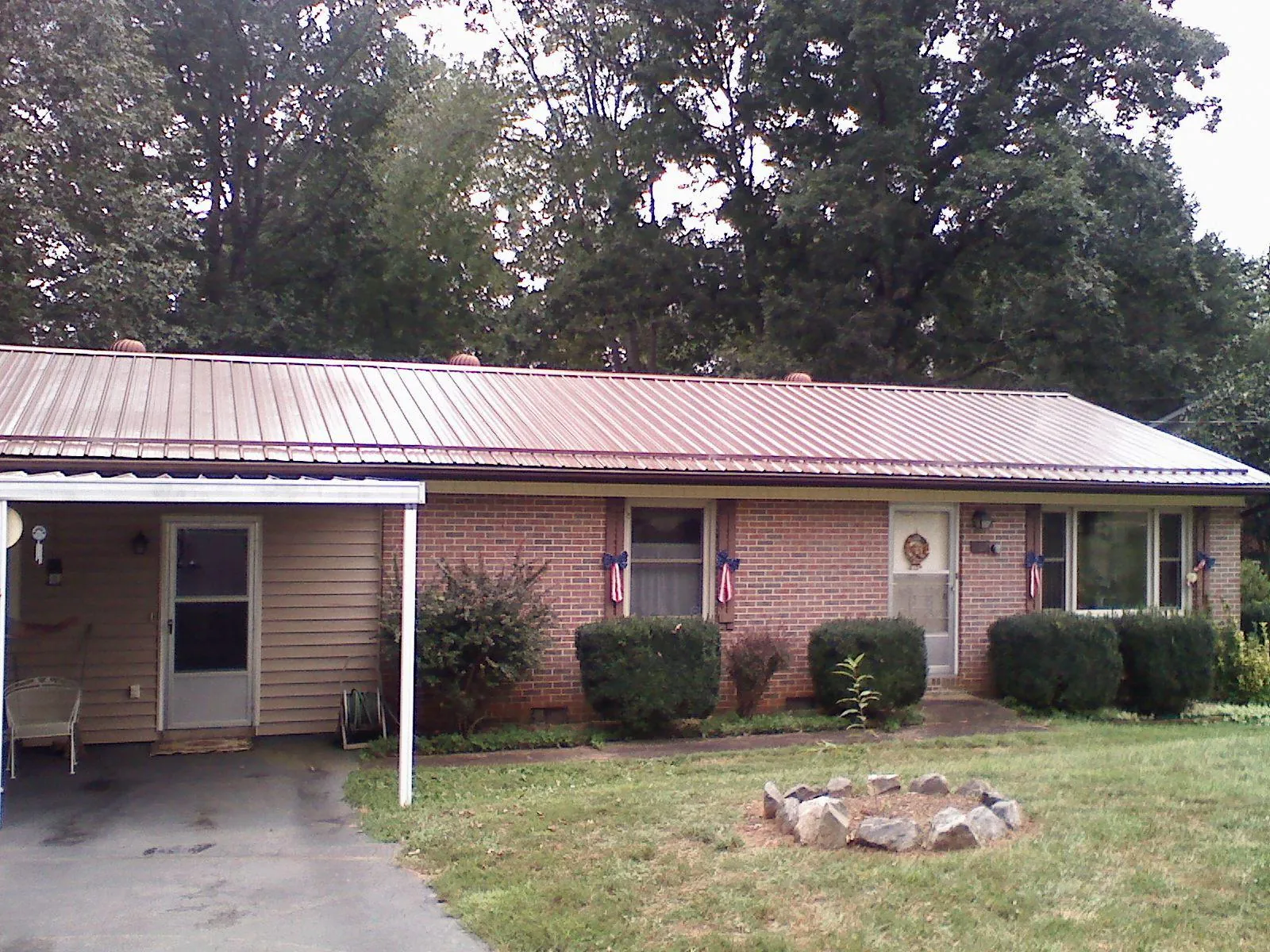 Bronze metal roof and carport on a brick ranch home — Roof Repair work by our crew in Verplanck